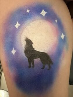 An image of a wolf howling at the moon.